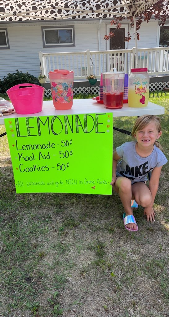 Hayden posing by her lemonade stand.
