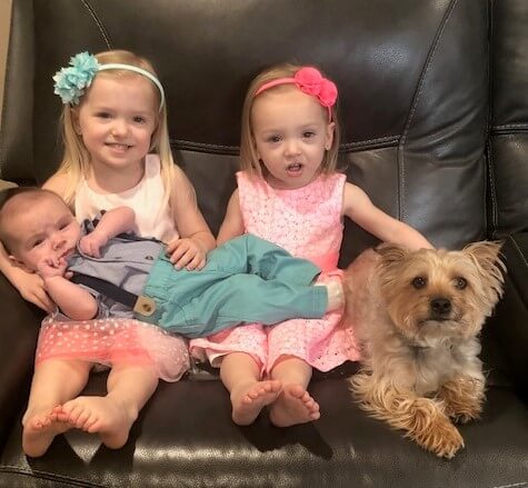 3 kids with a dog