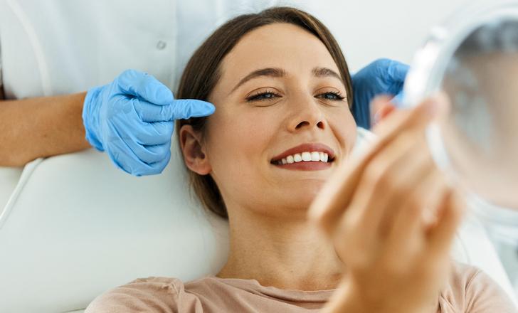 A patient looking at her face at a cosmetic consultation.