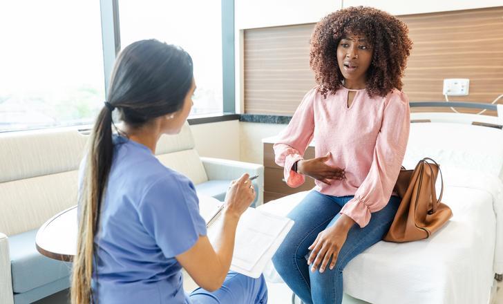 A patient talking to a nurse about IBS.