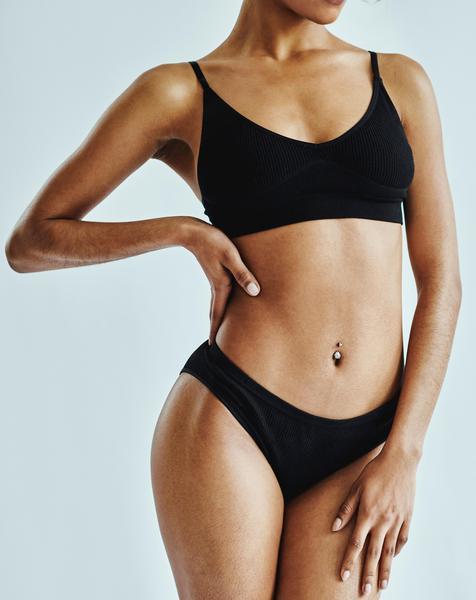 A person posing in a black bikini.