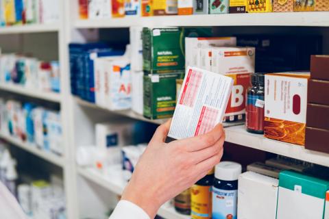 Hand-reaching-for-medication-on-shelf