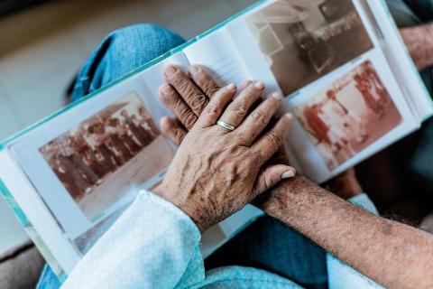 hands over photo book of memories