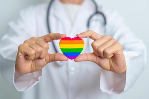 doctor holding rainbow heart