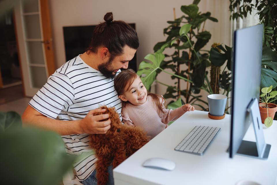 A dad working from home with a kid around.