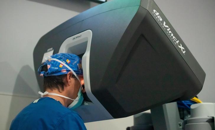 A surgeon performing robotic surgery.