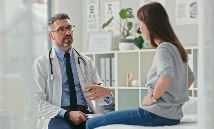 A patient talking to her doctor at at Gastroenterology visit.