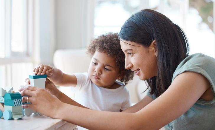 A child playing with blocks at a therapy appointment.