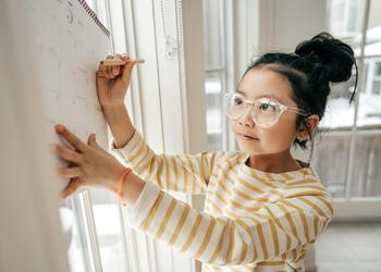 A child writing on a calendar.