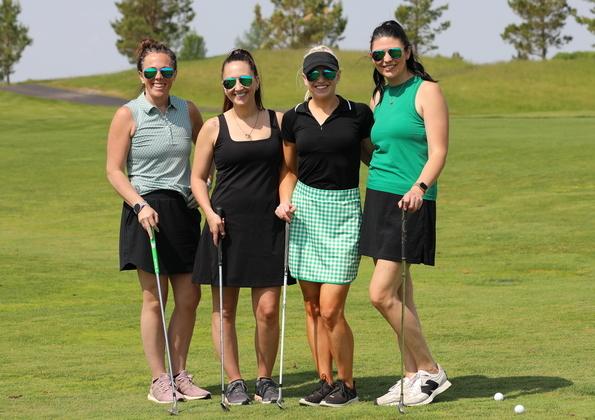 Four Altru employees at the Altru Cancer Golf Tournament.