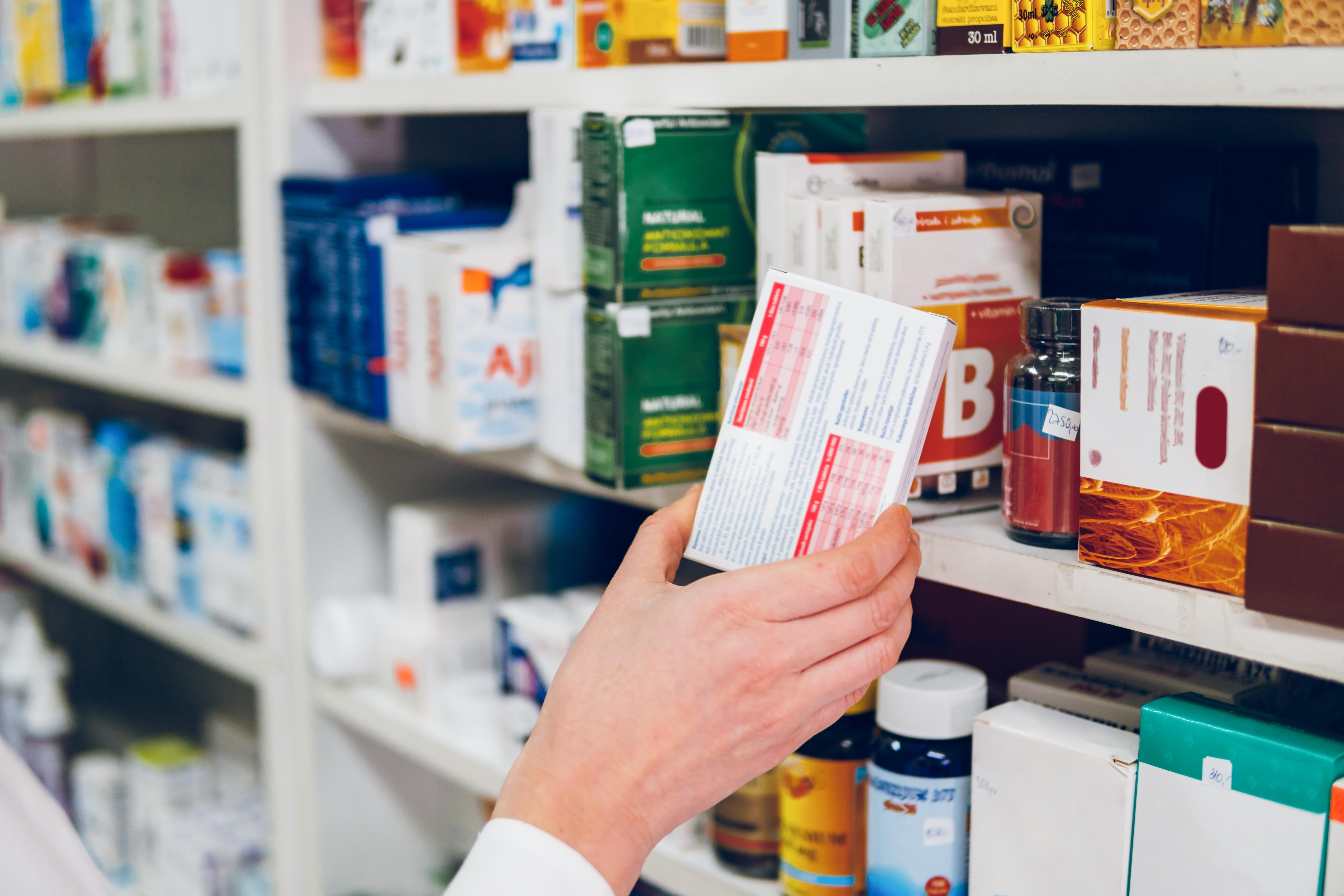 Hand-reaching-for-medication-on-shelf