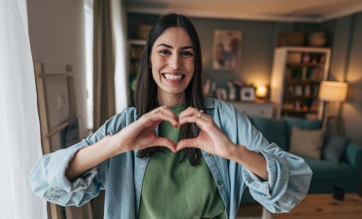 Women making heart shape with hands