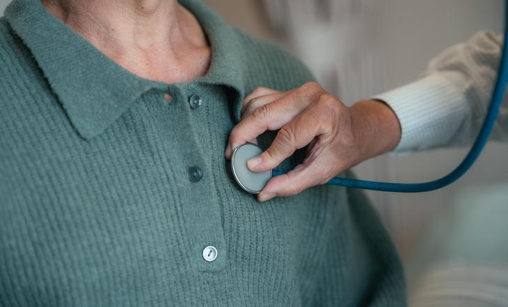 A provider listening to a patient's heart.