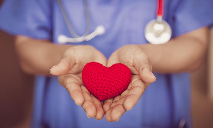 healthcare worker holding heart shaped object