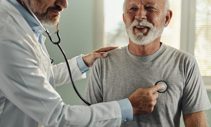 A provider listening to a patient's heart.