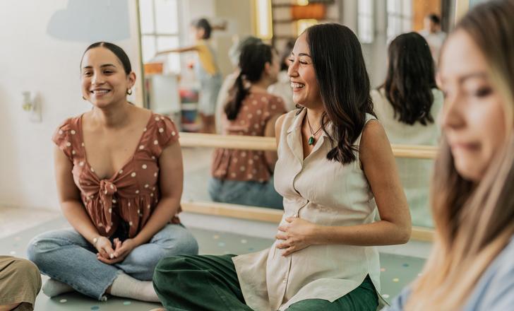Three pregnant people at a prenatal class.