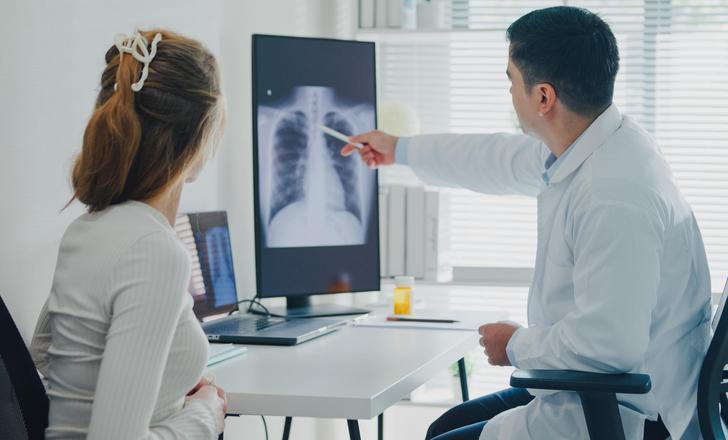 A provider explaining a lung xray to a patient.