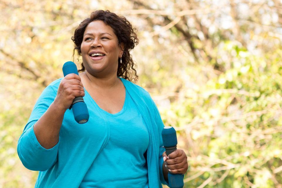 a women walking with hand weights