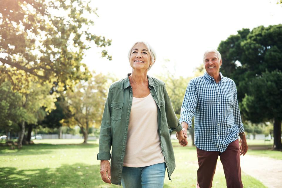 A couple walking together on a path in the park