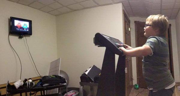 kid walking and watching tv