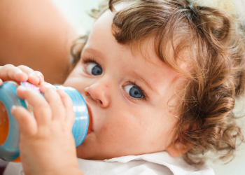 A baby drinking a bottle.