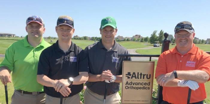 men posing in golf attire