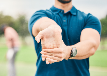 A row of golfers at the practice range before the Annual Altru Foundation Golf Tournament.